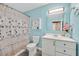 Bathroom with a vanity sink, toilet, shower with a seashell-themed curtain at 1595 E Camero Ave, Las Vegas, NV 89123