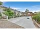Attractive home exterior featuring a covered patio area, lush greenery, and well-maintained landscaping at 1595 E Camero Ave, Las Vegas, NV 89123