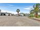 Charming home exterior with an oversized parking area, a shed, and desert landscaping at 1595 E Camero Ave, Las Vegas, NV 89123