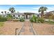 Charming single-story home with desert landscaping, palm trees, and a covered patio, perfect for outdoor relaxation at 1595 E Camero Ave, Las Vegas, NV 89123