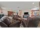 Comfortable living room with leather furniture, a stone fireplace, and seamless connection to the kitchen at 1595 E Camero Ave, Las Vegas, NV 89123