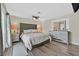 A spacious main bedroom with wood floors and views to the ensuite bathroom at 1595 E Camero Ave, Las Vegas, NV 89123