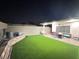 Spacious backyard featuring artificial turf, a covered patio, and ample room for activities at 1619 Tangerine Rose Dr, Las Vegas, NV 89142