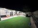 Expansive backyard with artificial turf, patio, and covered seating area perfect for outdoor entertaining at 1619 Tangerine Rose Dr, Las Vegas, NV 89142