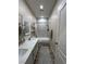 Bathroom featuring double sinks, modern fixtures, a shower-tub combo, and stylish flooring at 1619 Tangerine Rose Dr, Las Vegas, NV 89142