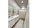 Bathroom featuring double sinks, modern fixtures, a shower-tub combo, and wood-look floors at 1619 Tangerine Rose Dr, Las Vegas, NV 89142
