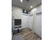 Bright bathroom with linen storage, wood-look flooring, and a view of the walk-in shower at 1619 Tangerine Rose Dr, Las Vegas, NV 89142