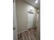 Hallway with wood floors, and white trim and an adjacent laundry room at 1619 Tangerine Rose Dr, Las Vegas, NV 89142