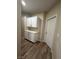 Hallway featuring wood floors, white trim and white cabinets at 1619 Tangerine Rose Dr, Las Vegas, NV 89142