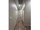 Hallway featuring wood floors, white trim, recessed lighting and access to multiple rooms at 1619 Tangerine Rose Dr, Las Vegas, NV 89142