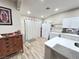 Bright kitchen featuring white cabinets, tiled backsplash, wood floors, and stainless steel appliances at 1619 Tangerine Rose Dr, Las Vegas, NV 89142