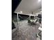 Relaxing covered patio with comfortable seating, a hammock, and scenic views of the landscaped yard at 1619 Tangerine Rose Dr, Las Vegas, NV 89142