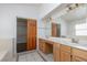 Bathroom featuring a double sink vanity and wood-look cabinets at 1924 Coralino Dr, Henderson, NV 89074