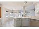 Open-concept kitchen with breakfast bar area overlooking a bright dining space at 1924 Coralino Dr, Henderson, NV 89074