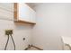 Compact laundry area with overhead shelving and connections for washer and dryer at 1924 Coralino Dr, Henderson, NV 89074