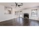 Open-concept living area with fireplace, wood-look floors and access to the backyard at 1924 Coralino Dr, Henderson, NV 89074