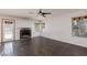 Cozy living room featuring a traditional fireplace, and wood-look floors at 1924 Coralino Dr, Henderson, NV 89074