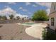 Backyard features a freeform in-ground pool surrounded by a concrete patio and a low-maintenance gravel yard at 1924 Coralino Dr, Henderson, NV 89074