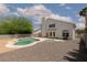 Backyard view featuring a freeform in-ground pool with a surrounding concrete patio and low-maintenance gravel landscaping at 1924 Coralino Dr, Henderson, NV 89074