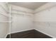 Spacious walk-in closet with custom shelving and wood-look floors at 1924 Coralino Dr, Henderson, NV 89074