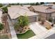 Aerial view of a well-maintained house with a spacious driveway, landscaping, and serene surroundings at 2021 Pelican Sky Beach Ave, North Las Vegas, NV 89081