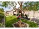 Beautiful backyard with artificial grass, patio, and landscaping features at 2021 Pelican Sky Beach Ave, North Las Vegas, NV 89081