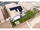 A beautiful desert landscaped backyard with solar panels, patio, and artificial grass at 2021 Pelican Sky Beach Ave, North Las Vegas, NV 89081