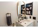 Contemporary bathroom with a modern sink, vanity and built-in shelving for ample storage at 2021 Pelican Sky Beach Ave, North Las Vegas, NV 89081