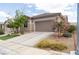 Inviting single-Gathering home with manicured lawn and beautiful landscaping, showcasing suburban charm at 2021 Pelican Sky Beach Ave, North Las Vegas, NV 89081