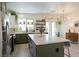 Modern kitchen with green cabinets, stainless steel appliances, a large island, and stylish pendant lighting at 2021 Pelican Sky Beach Ave, North Las Vegas, NV 89081