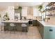 Stylish eat-in kitchen boasts stainless steel appliances, green cabinets, and a large center island with seating at 2021 Pelican Sky Beach Ave, North Las Vegas, NV 89081