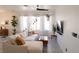 Relaxing living room features a plush sectional sofa, a modern ceiling fan, and contemporary decor at 2021 Pelican Sky Beach Ave, North Las Vegas, NV 89081