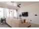 Bright living room with large windows, a comfortable white sofa, and minimalist modern decor at 2021 Pelican Sky Beach Ave, North Las Vegas, NV 89081