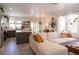 Spacious living room with a comfortable white couch, stylish decor, and an open layout to the kitchen at 2021 Pelican Sky Beach Ave, North Las Vegas, NV 89081