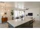 Open living space featuring a kitchen island with modern cabinets, a comfortable couch, and contemporary lighting at 2021 Pelican Sky Beach Ave, North Las Vegas, NV 89081
