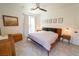 The main bedroom is well lit with a large window and features decorative artwork and natural wood furniture at 2021 Pelican Sky Beach Ave, North Las Vegas, NV 89081