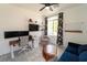 Bright office space with dual monitors, desk, and comfortable seating area, ideal for working from home at 2021 Pelican Sky Beach Ave, North Las Vegas, NV 89081