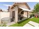 Covered patio with seating area and lush backyard features at 2021 Pelican Sky Beach Ave, North Las Vegas, NV 89081