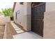 Side entrance with pathway and security gate for added privacy and charm at 2021 Pelican Sky Beach Ave, North Las Vegas, NV 89081