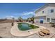 In-ground pool with decorative surround in a spacious backyard with mature landscaping, offering a private retreat at 2147 Bridle Wreath Ln, Las Vegas, NV 89156