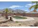Backyard with an in-ground pool, mature landscaping, a wood bridge, and a privacy fence at 2147 Bridle Wreath Ln, Las Vegas, NV 89156