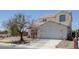 Charming two-story home with a two-car garage, desert landscaping, and a concrete driveway at 2147 Bridle Wreath Ln, Las Vegas, NV 89156