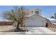 Charming home featuring a two-car garage, landscaped yard, and classic architecture at 2147 Bridle Wreath Ln, Las Vegas, NV 89156