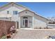 Charming home featuring stucco siding, desert landscaping and a decorative metal security door at 2147 Bridle Wreath Ln, Las Vegas, NV 89156