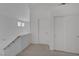 Upstairs hallway featuring neutral paint, carpeted flooring and simple design at 2147 Bridle Wreath Ln, Las Vegas, NV 89156