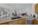 Open-concept kitchen featuring stainless steel appliances, tile countertops and view into living space at 2147 Bridle Wreath Ln, Las Vegas, NV 89156