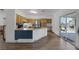 Spacious kitchen featuring a center island, wood cabinets, stainless steel appliances, and sliding glass doors at 2147 Bridle Wreath Ln, Las Vegas, NV 89156