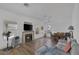 Bright open-concept living room with hardwood floors, fireplace, and dining area at 2147 Bridle Wreath Ln, Las Vegas, NV 89156