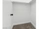 A clean, walk-in closet featuring carpeted floors and a clothing rack at 2201 Ramsgate Dr # 327, Henderson, NV 89074