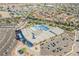 A bird's eye view of the community pool, tennis courts, and surrounding residential area at 2201 Ramsgate Dr # 327, Henderson, NV 89074